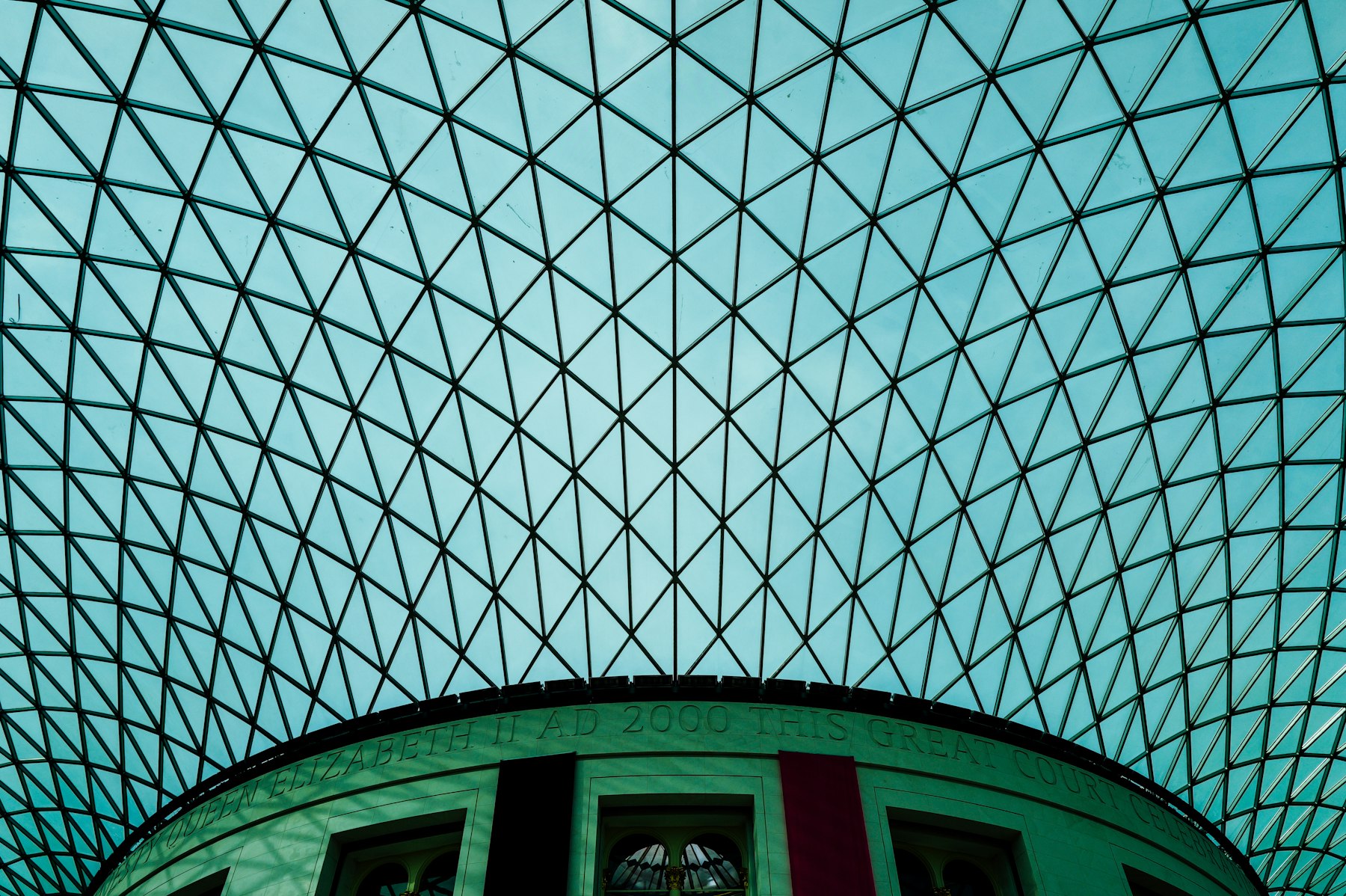 A geometric glass roof over a museum courtyard