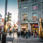 Shoppers walking along a busy London shopping street