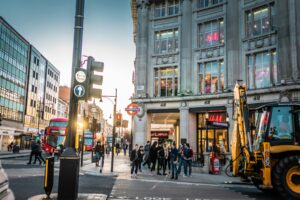 Shoppers walking along a busy London shopping street