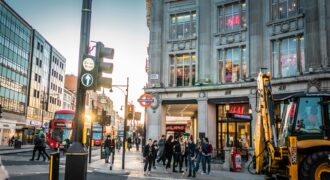 Shoppers walking along a busy London shopping street