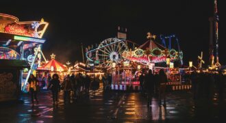 Funfair rides lit up at night